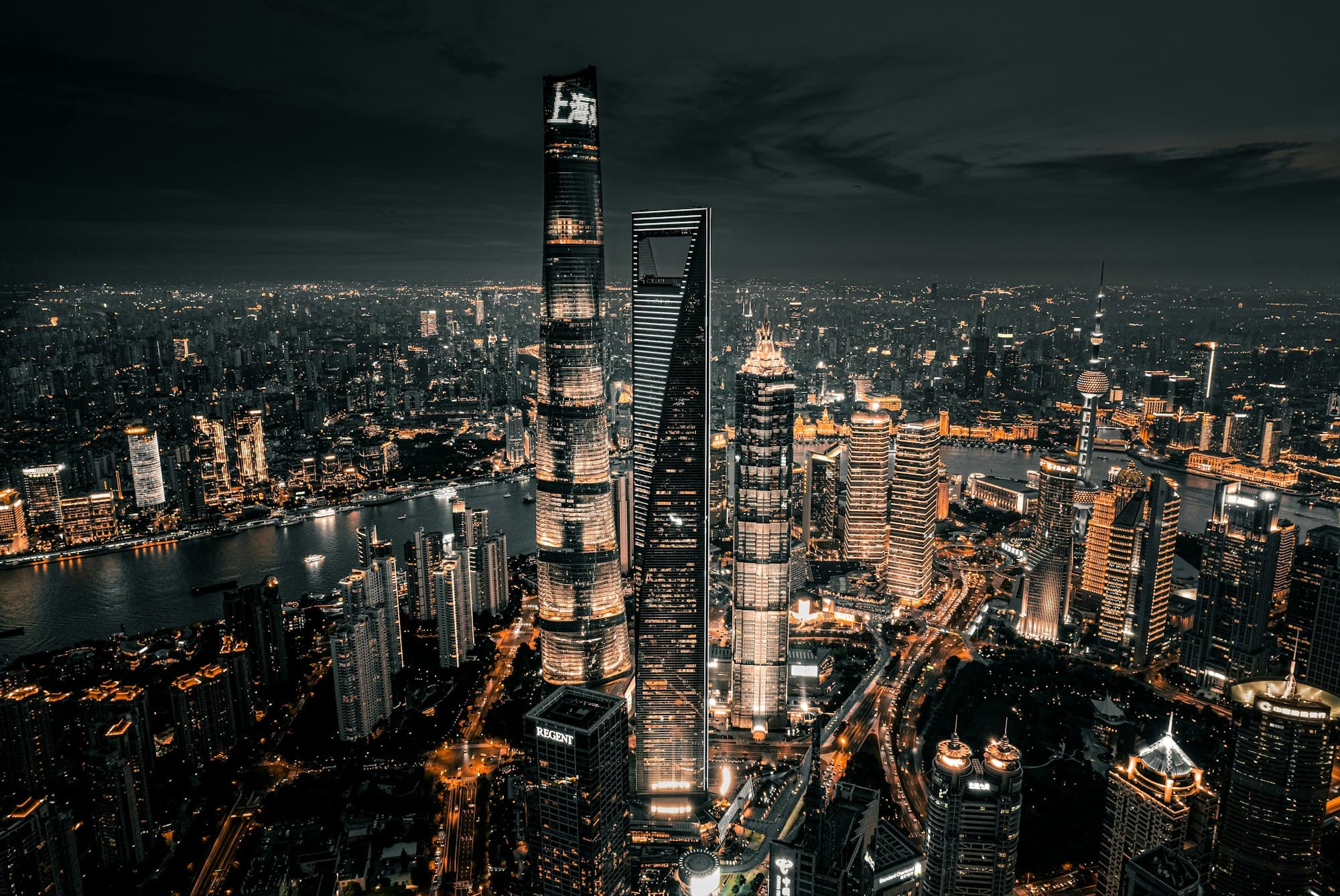 The Shanghai skyline lit at night across the Huangpu river