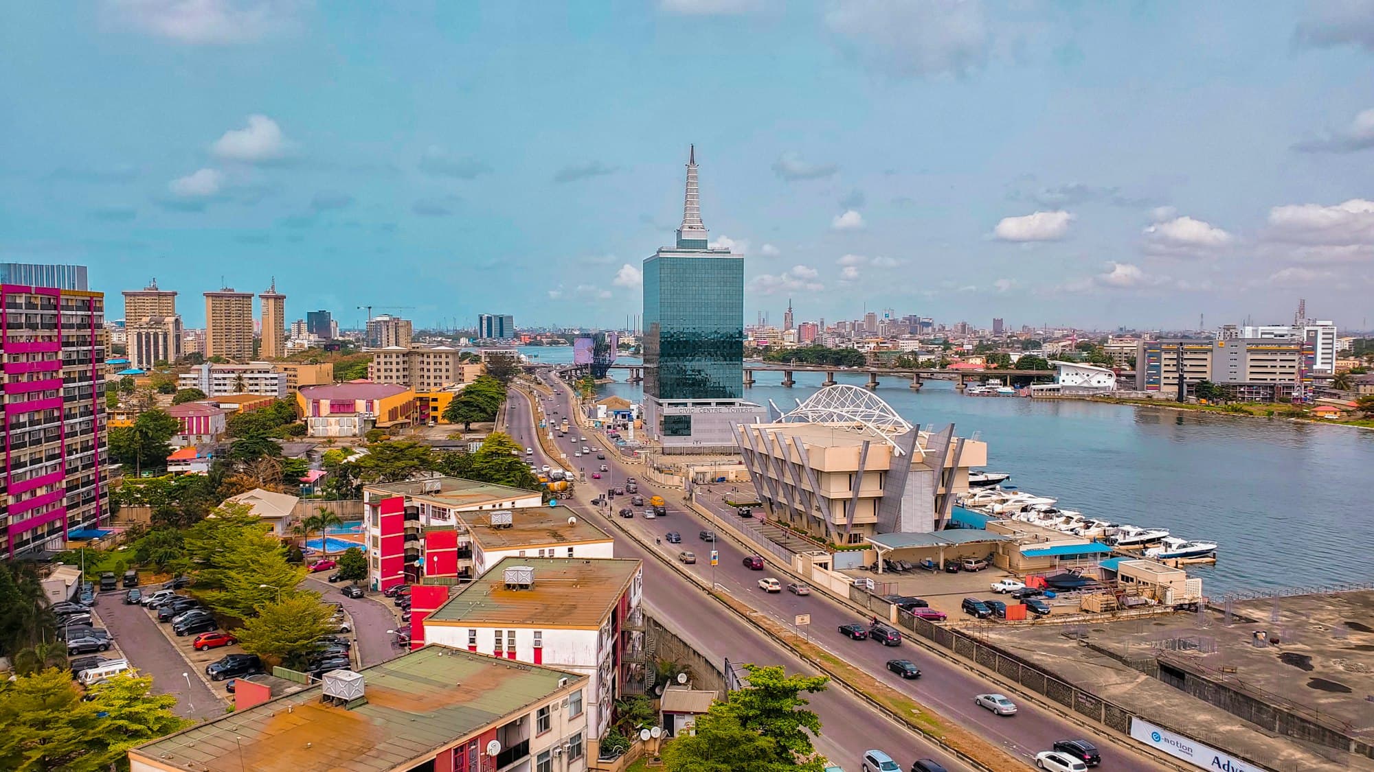 Lagos from the air at dusk, with the lagoon behind the city